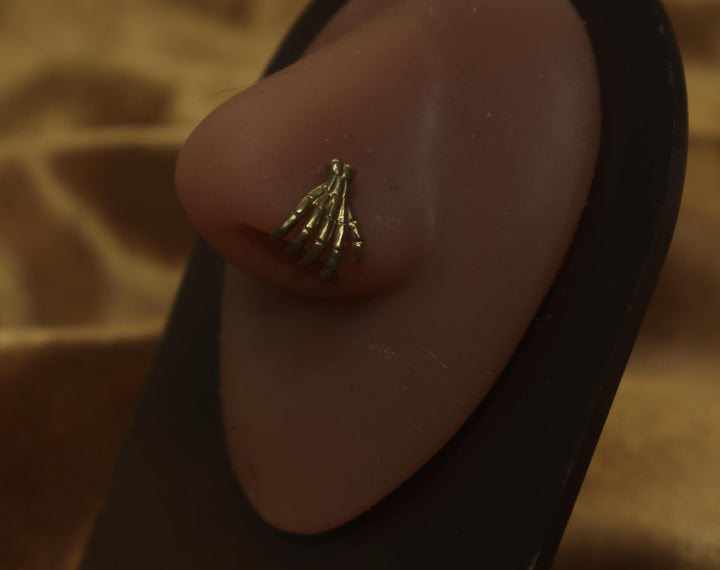Spooky Skeleton Hand Holding Nose Piercing