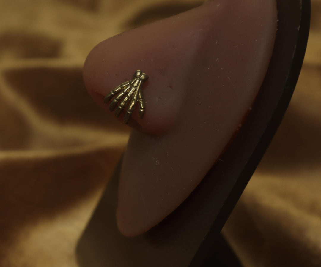 Spooky Skeleton Hand Holding Nose Piercing